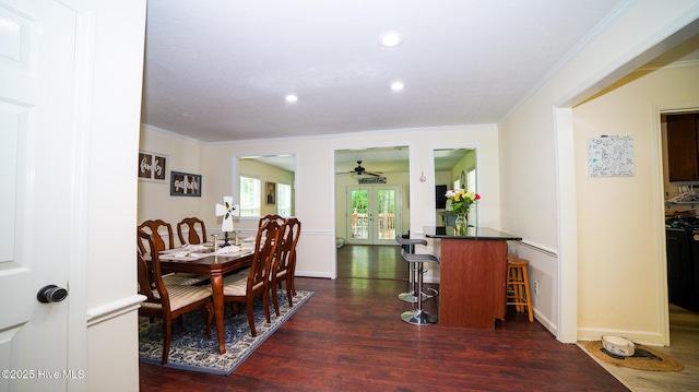 dining space with ceiling fan, french doors, dark hardwood / wood-style flooring, and ornamental molding