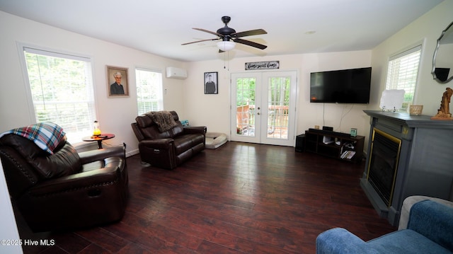 living room with dark hardwood / wood-style floors, ceiling fan, french doors, and an AC wall unit