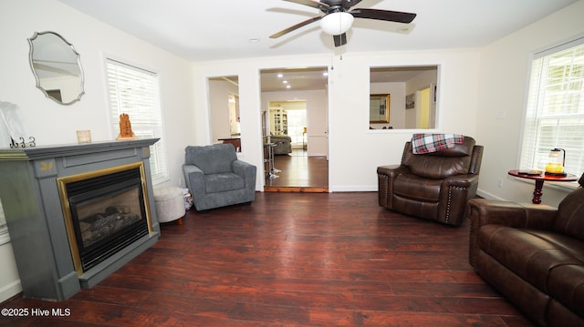 living room with ceiling fan, a wealth of natural light, and dark hardwood / wood-style floors