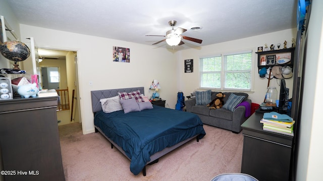 bedroom with ceiling fan and carpet