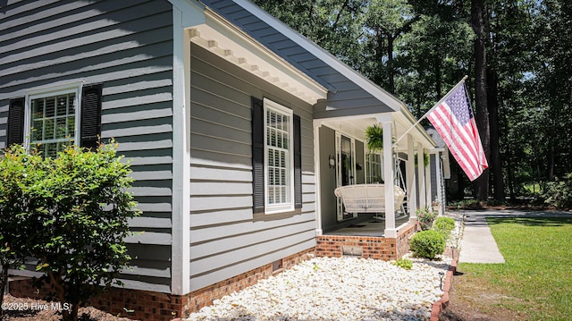 view of side of property with covered porch