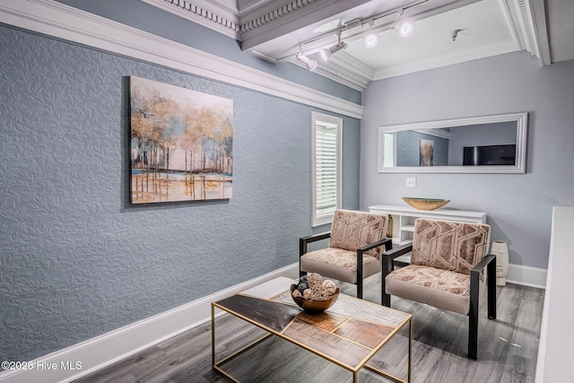 interior space with ornamental molding, track lighting, and hardwood / wood-style flooring