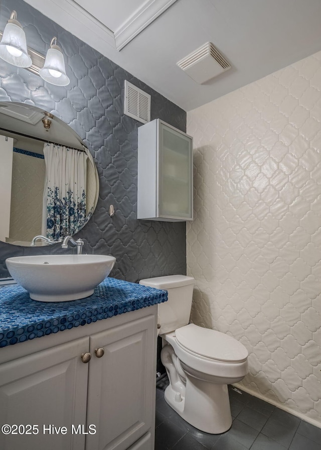 bathroom featuring toilet, tile patterned flooring, and vanity