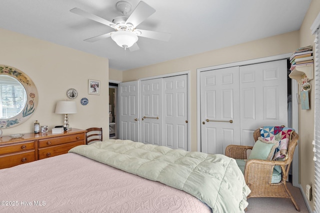 bedroom featuring ceiling fan and two closets