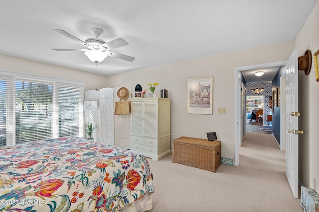 bedroom with ceiling fan and light colored carpet