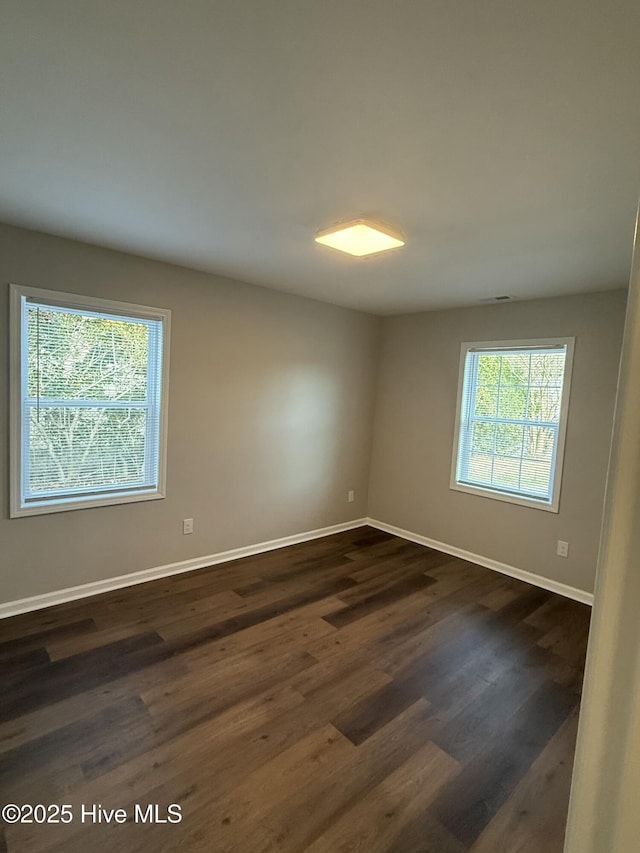 unfurnished room featuring dark hardwood / wood-style flooring