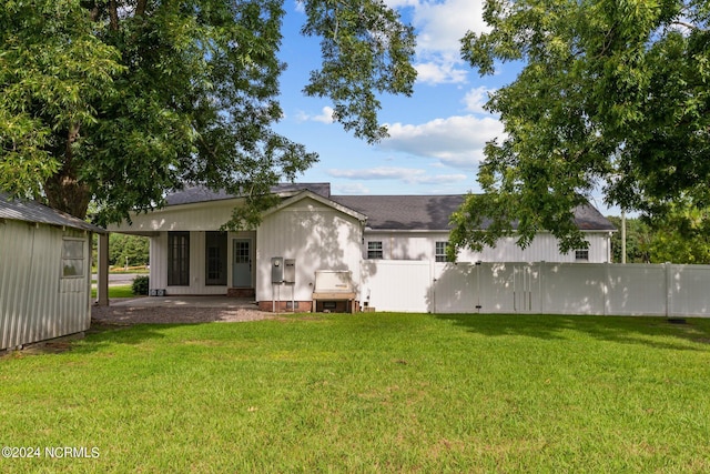 back of house featuring french doors and a yard