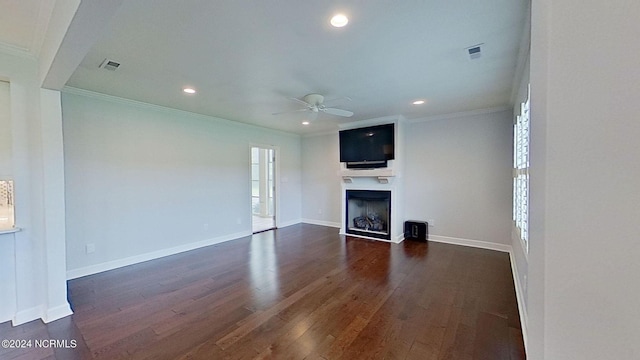 unfurnished living room with ceiling fan, dark hardwood / wood-style flooring, and ornamental molding