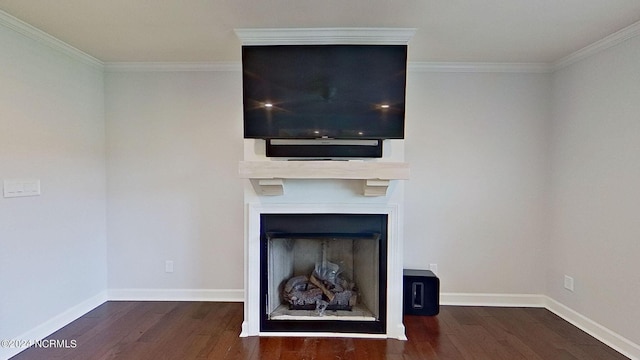 unfurnished living room with a large fireplace, crown molding, and dark hardwood / wood-style floors