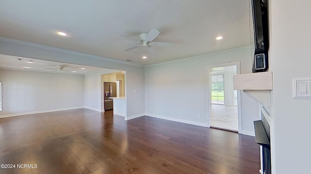 unfurnished living room featuring ceiling fan, dark wood-type flooring, and ornamental molding