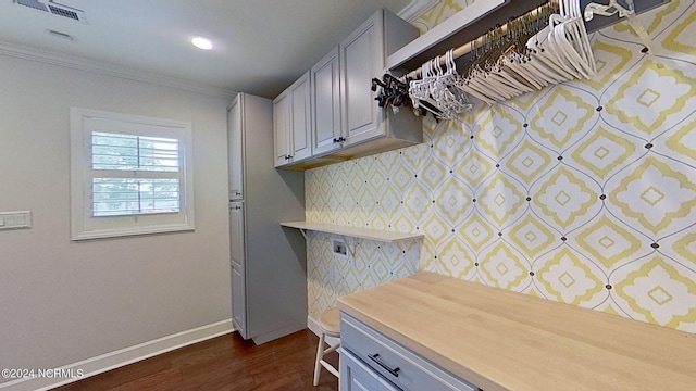 kitchen with dark wood-type flooring and ornamental molding