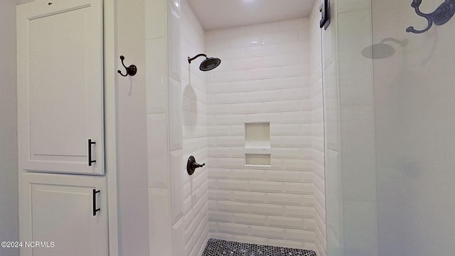 bathroom with a shower with door