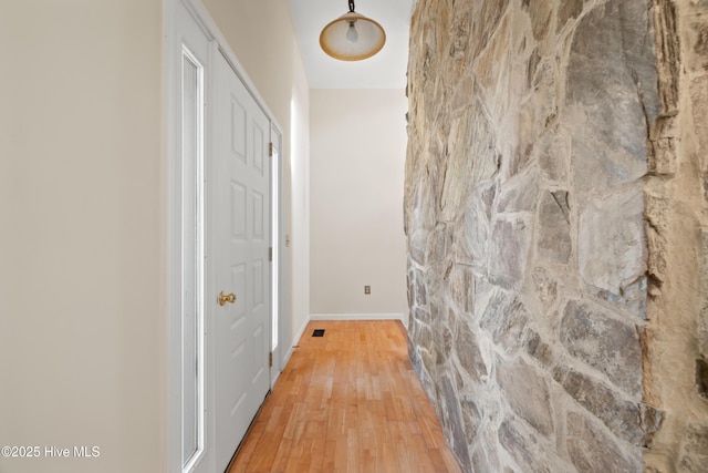 hallway featuring wood-type flooring