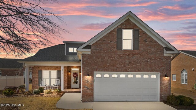 front of property with covered porch and a garage