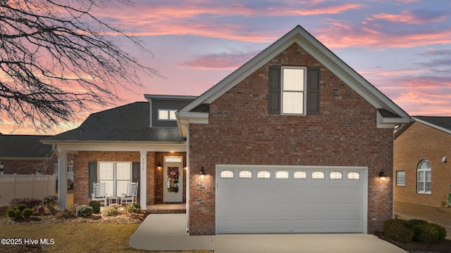 front facade with a garage and a porch