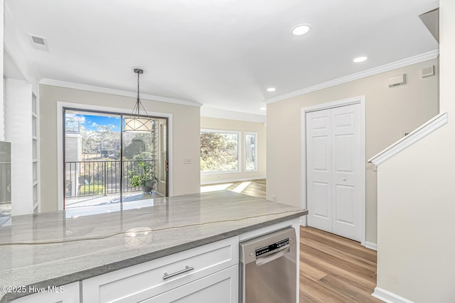 kitchen with white cabinets, hanging light fixtures, light stone counters, stainless steel dishwasher, and light hardwood / wood-style flooring