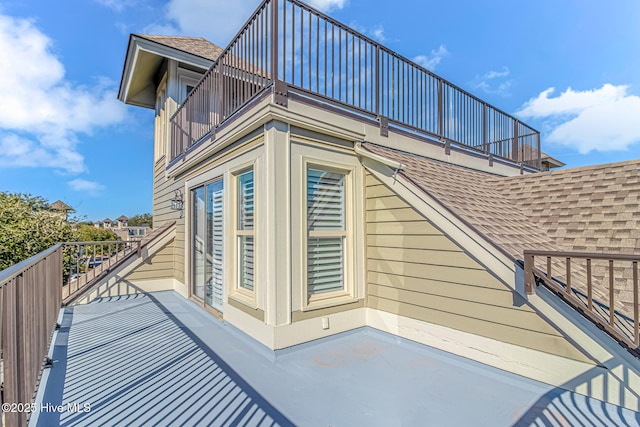 view of side of home featuring a balcony