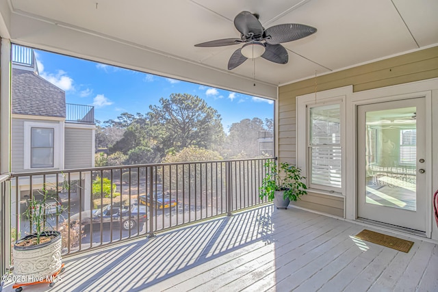 unfurnished sunroom featuring ceiling fan