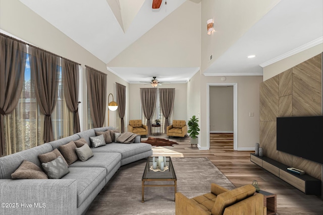 living room with ceiling fan, lofted ceiling, crown molding, and hardwood / wood-style flooring