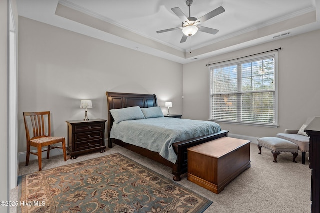 bedroom featuring a raised ceiling, crown molding, carpet floors, and ceiling fan