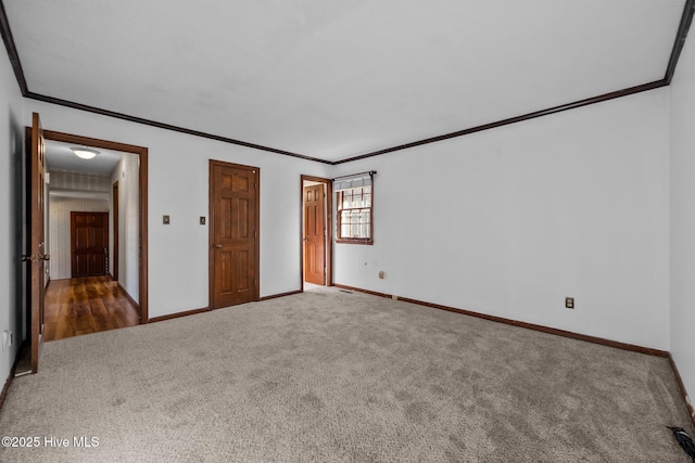 unfurnished bedroom with crown molding and dark carpet