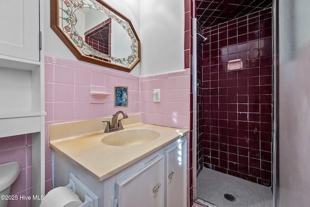 bathroom with toilet, vanity, tile walls, and an enclosed shower