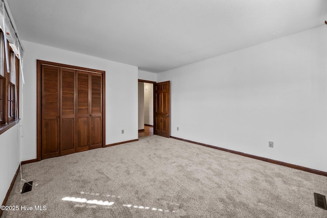 unfurnished bedroom featuring a closet and carpet