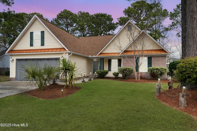 view of front of property featuring a garage and a yard