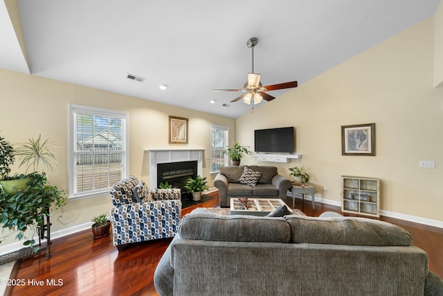 living room featuring ceiling fan, lofted ceiling, and dark hardwood / wood-style floors