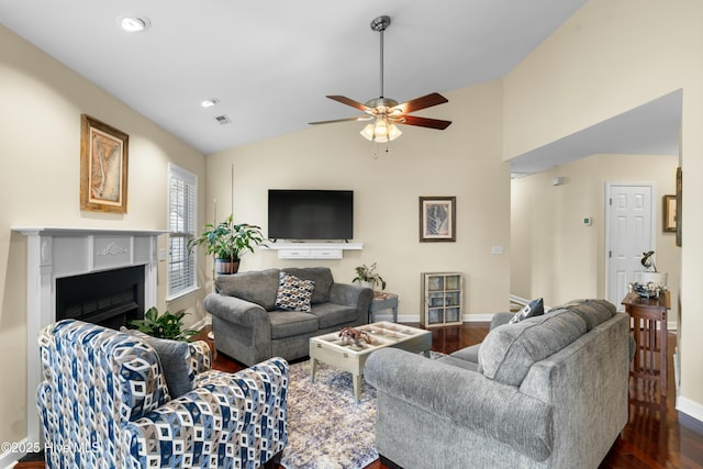 living room with dark hardwood / wood-style flooring, vaulted ceiling, and ceiling fan