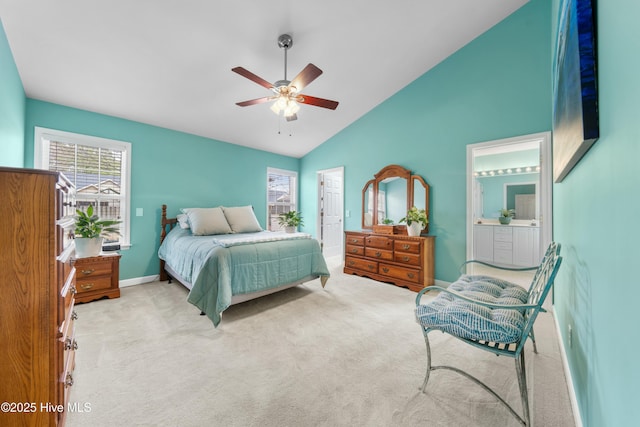 carpeted bedroom featuring high vaulted ceiling, ceiling fan, and ensuite bathroom