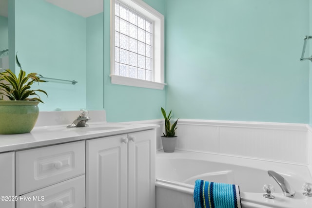 bathroom featuring vanity and a tub to relax in