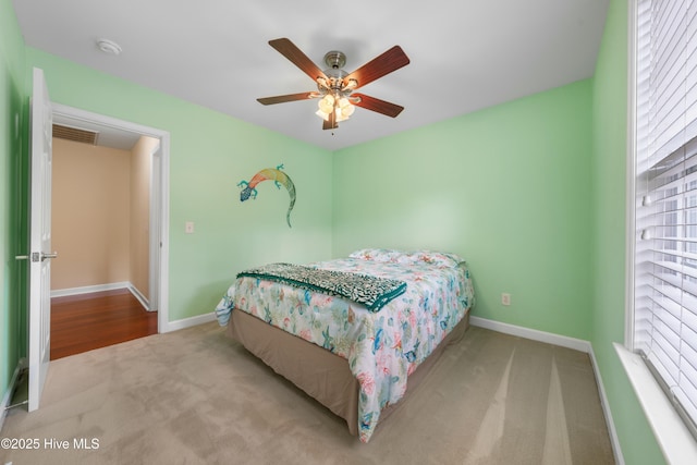 carpeted bedroom with ceiling fan