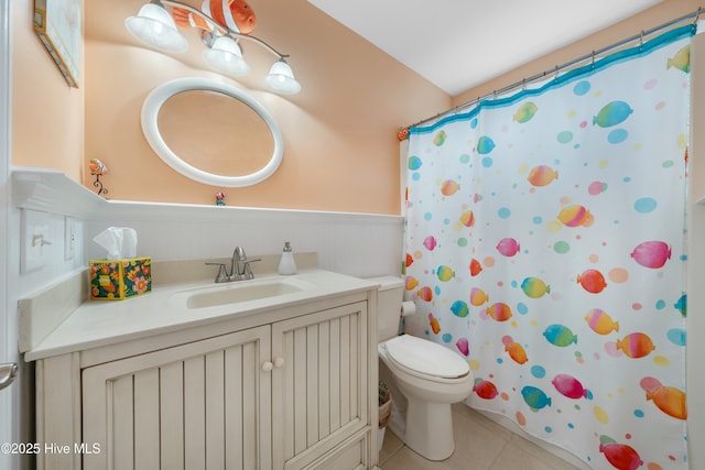 bathroom with tile patterned flooring, vanity, toilet, and walk in shower