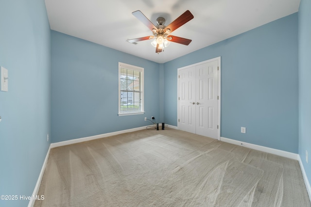 unfurnished room featuring light colored carpet and ceiling fan