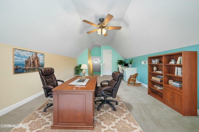 office featuring vaulted ceiling, light colored carpet, and ceiling fan