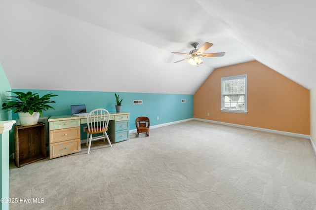 home office featuring vaulted ceiling, light carpet, and ceiling fan