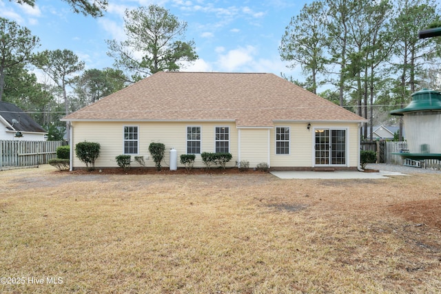 back of house with a patio area and a lawn