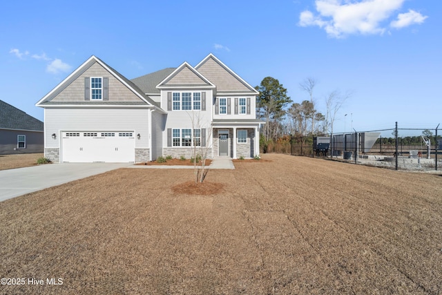 craftsman house featuring a garage and a front yard