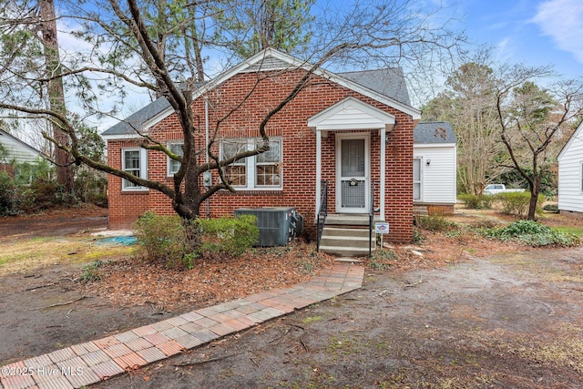 bungalow-style home with central AC unit