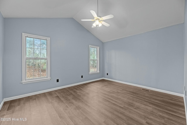 unfurnished room with hardwood / wood-style flooring, vaulted ceiling, and ceiling fan