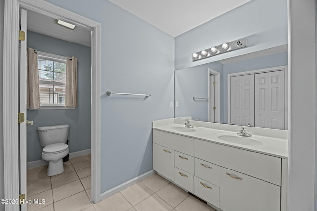 bathroom featuring tile patterned flooring, vanity, and toilet