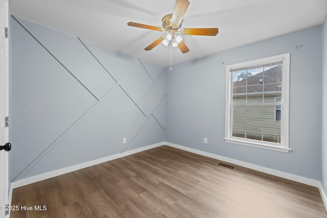 spare room with hardwood / wood-style flooring and ceiling fan