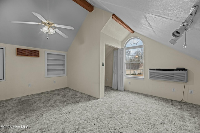 unfurnished living room featuring an AC wall unit, carpet floors, and vaulted ceiling with beams