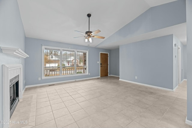 unfurnished living room with vaulted ceiling, light tile patterned floors, and ceiling fan