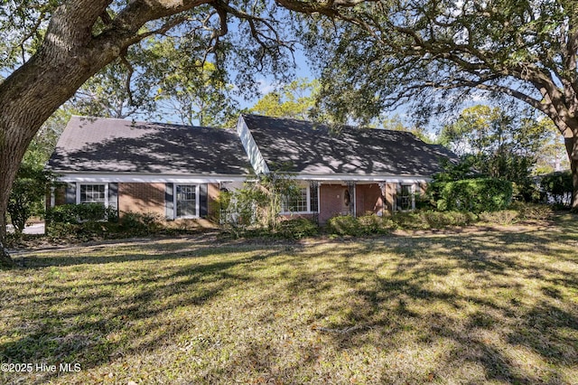 back of property with a lawn