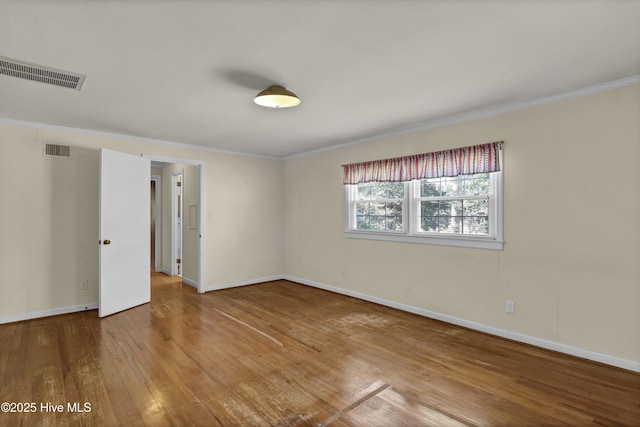 unfurnished room with crown molding and hardwood / wood-style flooring