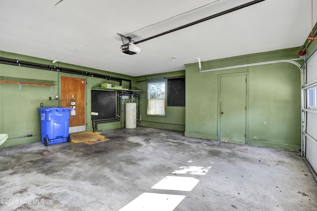 garage featuring water heater and a garage door opener