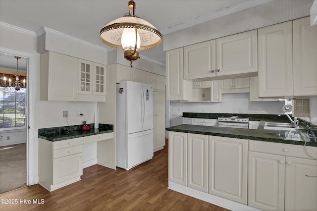 kitchen with white cabinets, hanging light fixtures, and white appliances