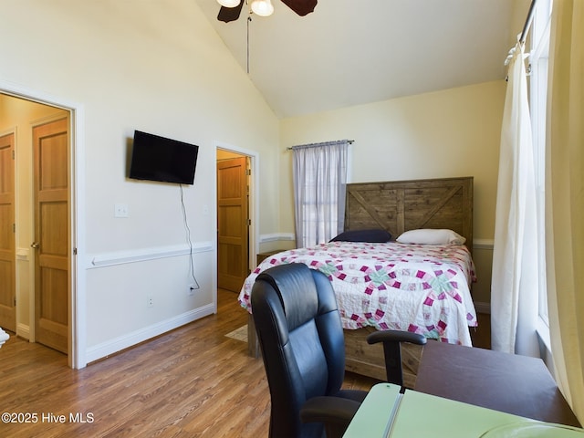 bedroom with ceiling fan, wood-type flooring, and high vaulted ceiling